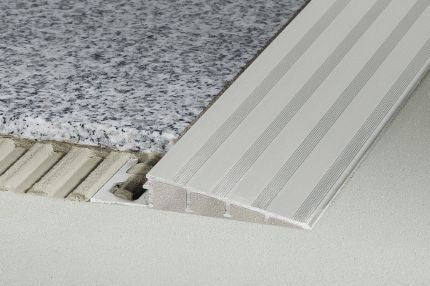 Schluter® RENO-RAMP/-K transition profile for reducing to lower elevations in commercial spaces