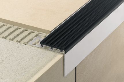 Schluter® TREP-TAP profile that integrates with TREP-S, TREP-B to conceal top of stair risers